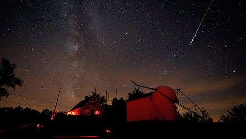 A bright Perseid meteor streaked down Saturday night (Aug. 7, 2010) over buildings at the Stellafane amateur astronomy convention in Springfield, Vermont.