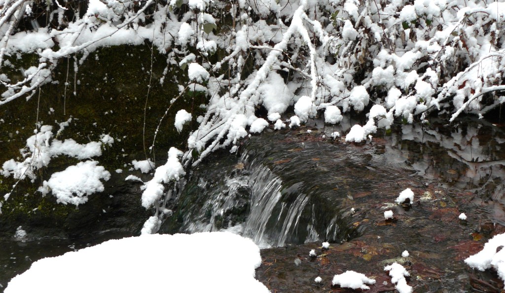 Water flowing over the edge of the dam.