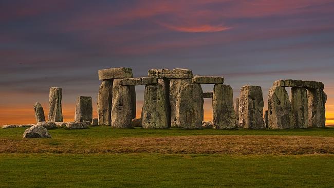 Stonehenge at Dawn. On the morning of Mid-Summer's Day the sun rises exactly over the heel stone.