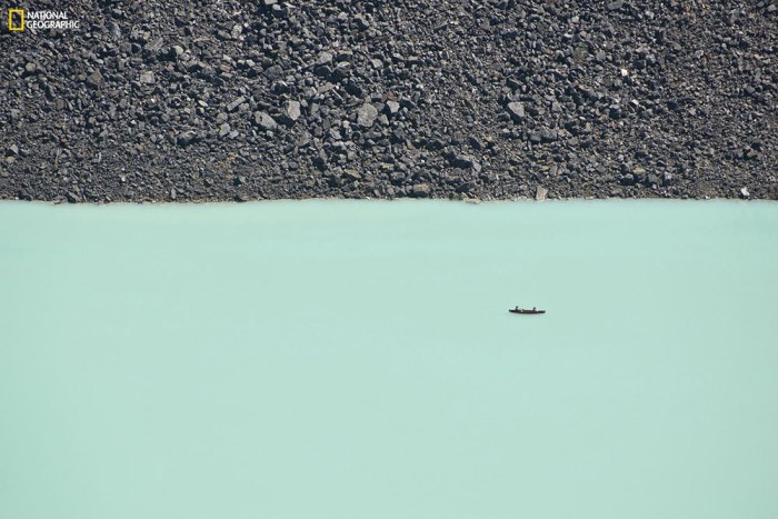 "This disorienting photo was taken from a cliff overlooking Lake Louise. Two people are enjoying a canoe ride on the lake's turquoise waters. Even boulders the size of large cars seem like pebbles from a high vantage point." Location: Lake Louise, Banff National Park, Alberta, Canada. Photo by Ben Leshchinsky.