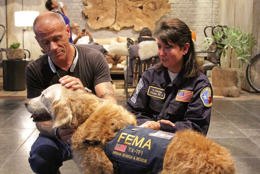 Bretagne with a firefighter and her owner and handler, Denise Corliss during her "Dog's Best Day." (Photo: BarkPost)