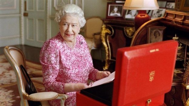 Newly released official photographs show the Queen with her official red box, containing the day's policy papers, cabinet documents, Foreign Office papers and other letters.