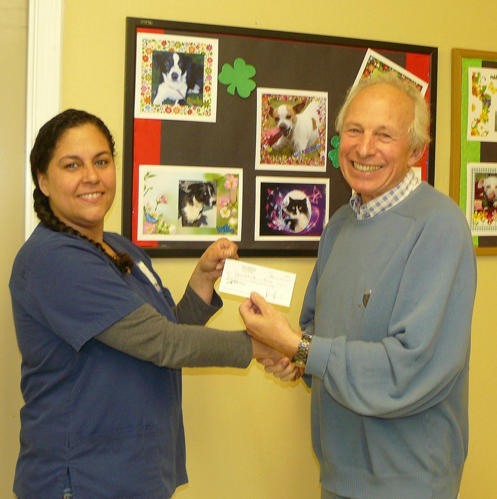 Yours truly passing a cheque to the value of $750 to Margaret Varner, Director of Facility Operations.