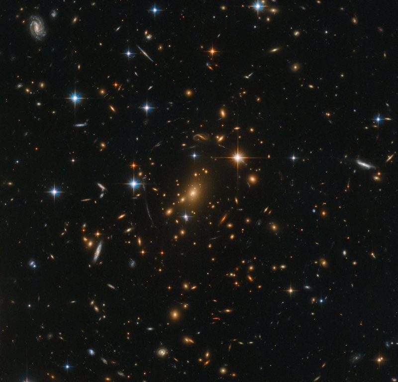 Here’s the original Hubble image of galaxy cluster RXC J0142.9+4438, later “sonified” by Russo and Santaguida. NASA wrote: “Galaxies abound in this spectacular Hubble image; spiral arms swirl in all colors and orientations, and fuzzy ellipticals can be seen speckled across the frame as softly glowing smudges on the sky. Each visible speck of a galaxy is home to countless stars. A few stars closer to home shine brightly in the foreground, while a massive galaxy cluster nestles at the very center of the image; an immense collection of maybe thousands of galaxies, all held together by the relentless force of gravity.” Read more about this image, which is via ESA/ Hubble & NASA, RELICS.